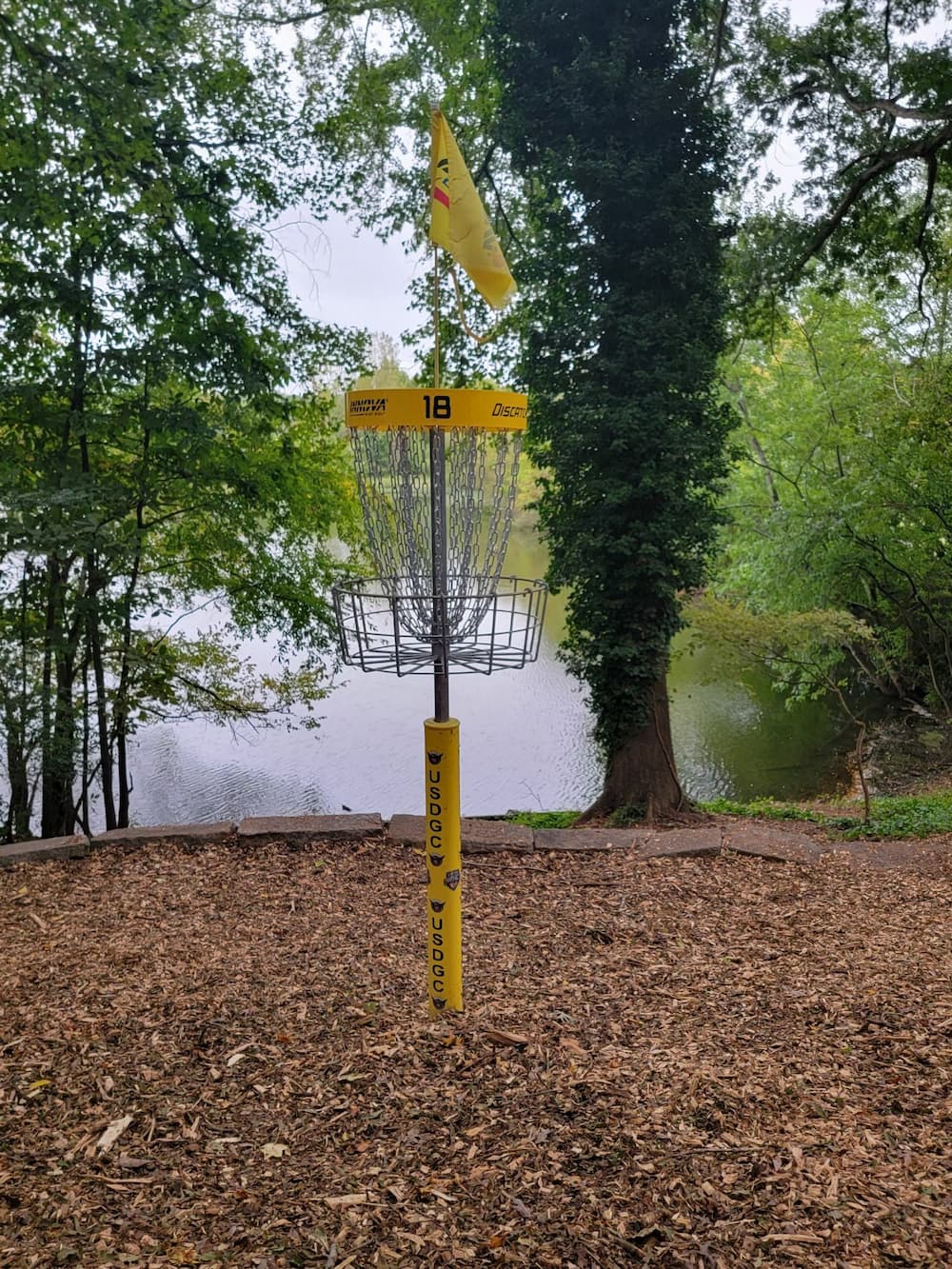 yellow structure in the ground overlooking a body of water